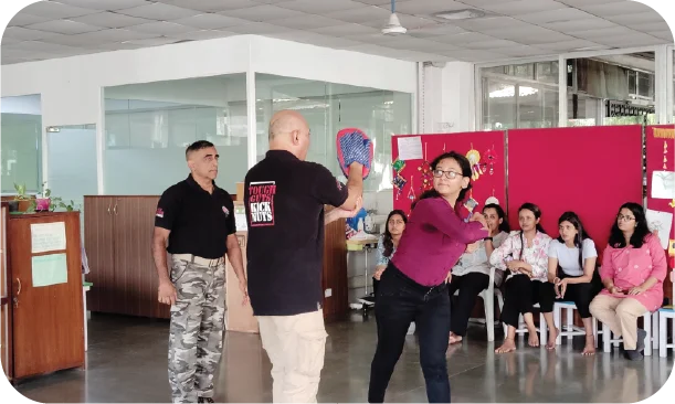 Instructor teaching defensive stance and reaction techniques to participants